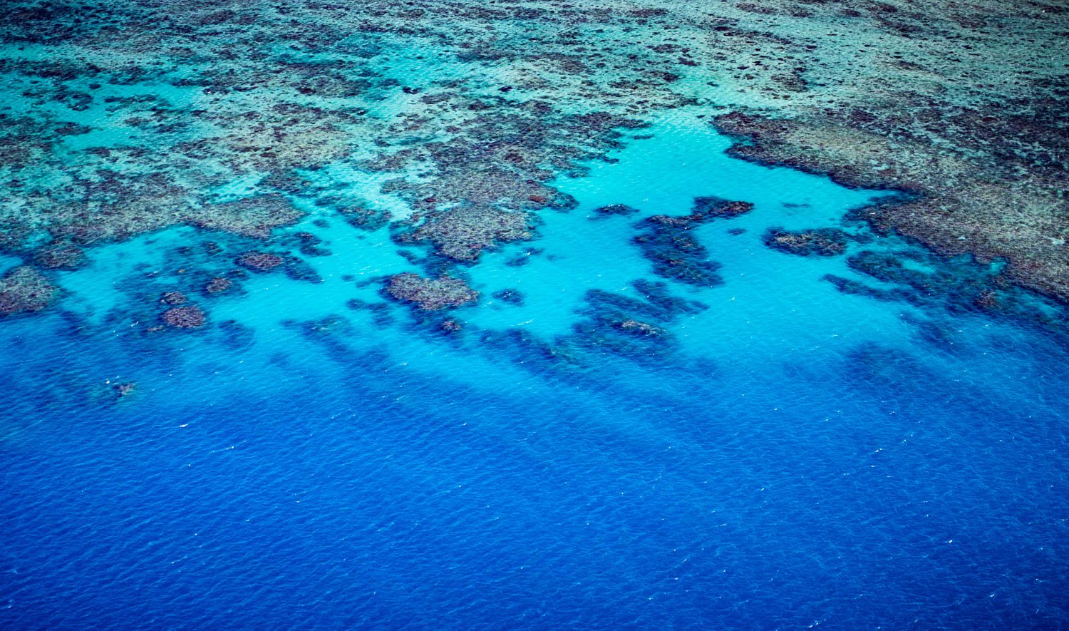 Aerial view of the shiny blue lake with a lot of small stony islands, The Great Barrier Reef, Far North Queensland