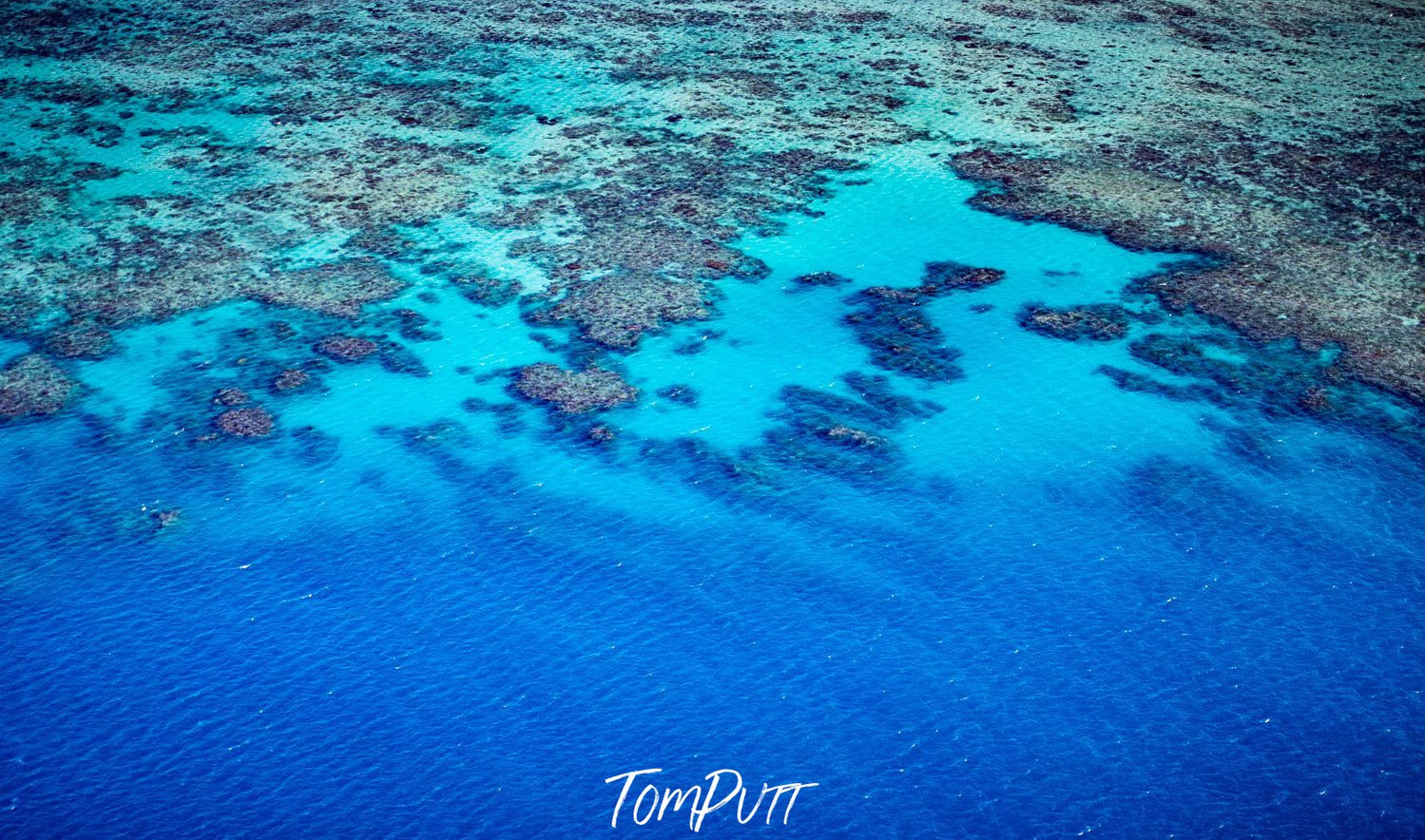 Aerial view of the shiny blue lake with a lot of small stony islands, The Great Barrier Reef, Far North Queensland