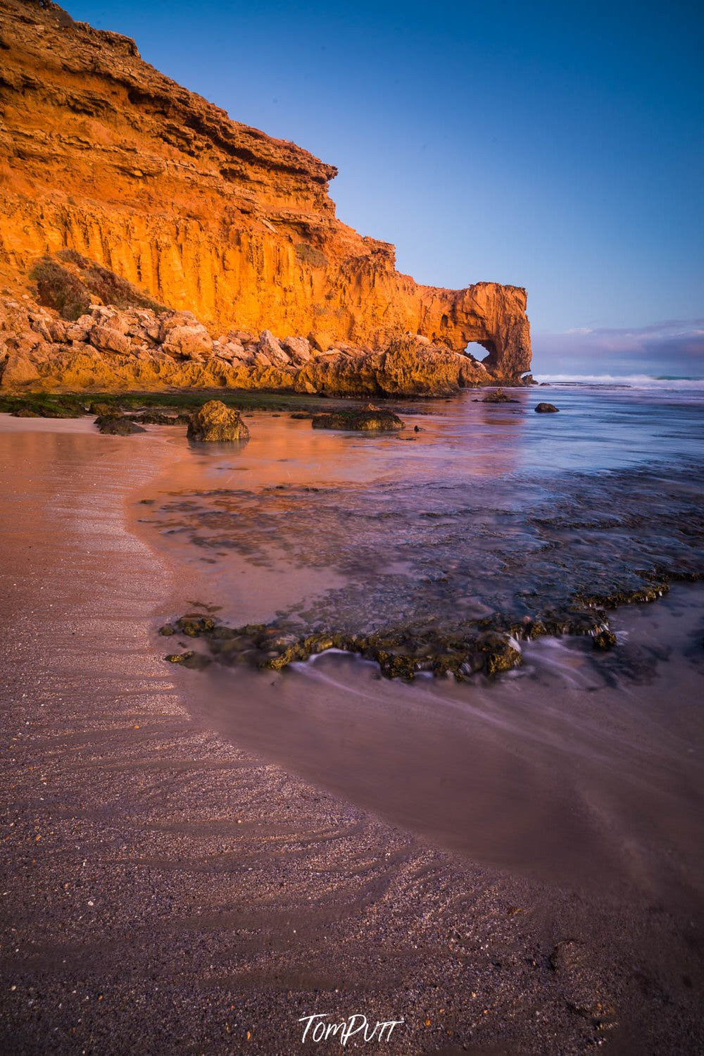 A long mountain wall with golden color and a sea corner below, The Needle Eye at Venus Bay #2, Eyre Peninsula