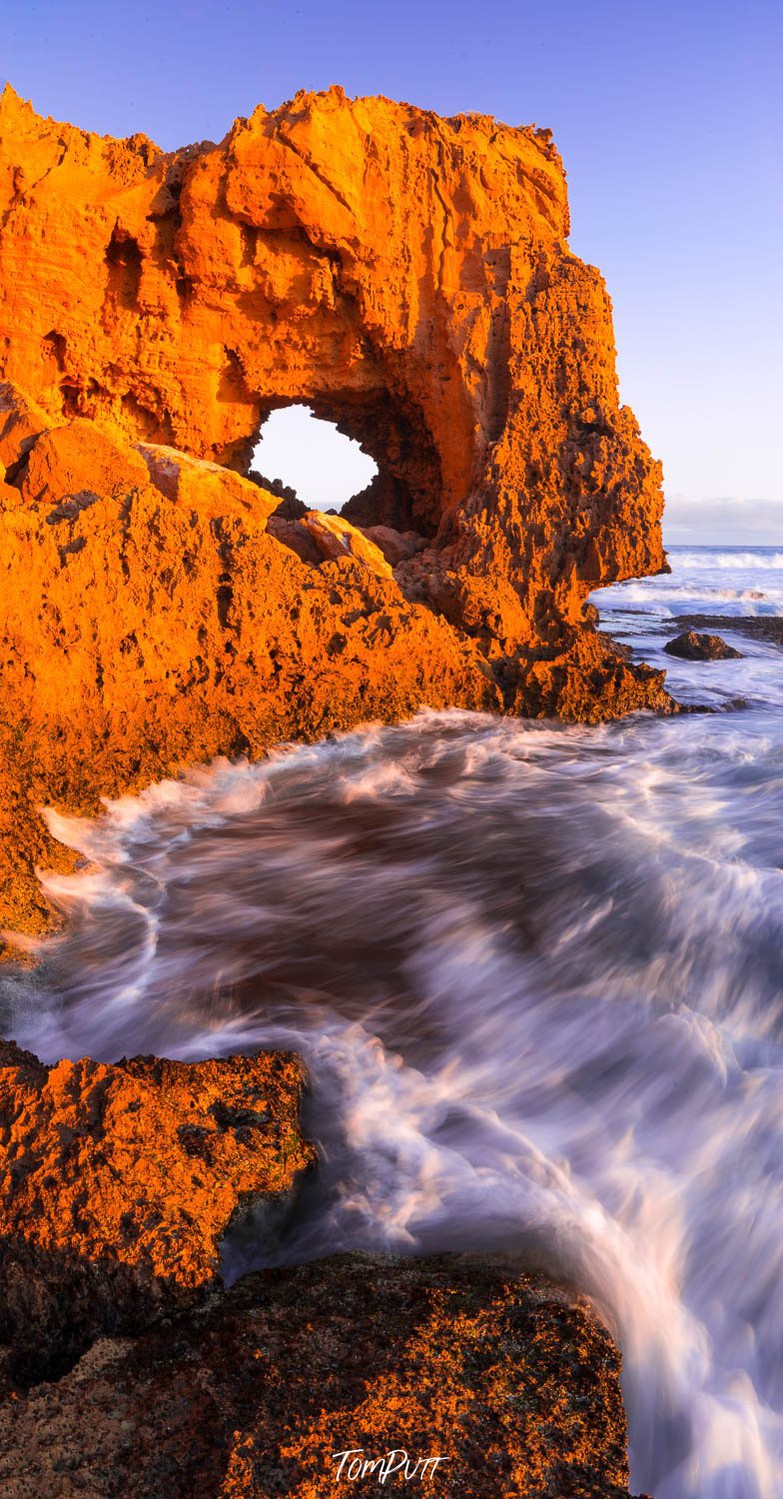 A long mountain wall with a golden color and a sea corner below, The Needle Eye at Venus Bay, Eyre Peninsula