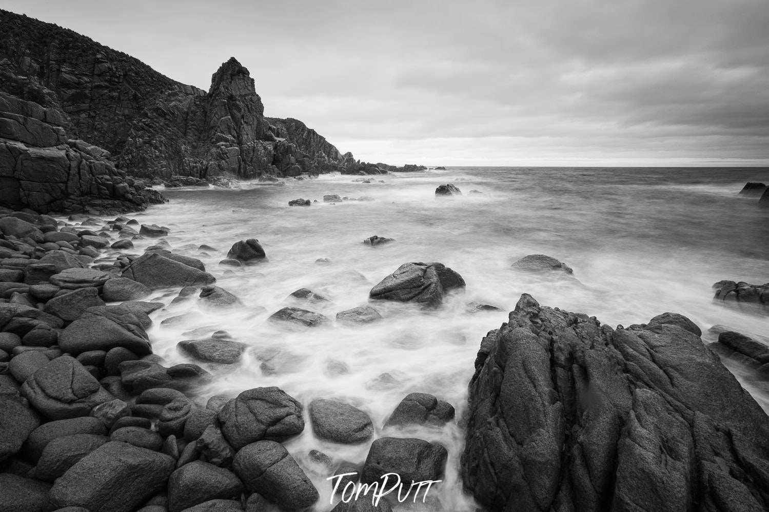 A beach with a lot of rounded stones and some standing sculpture of stones behind, The Pinnacles 4, Phillip Island