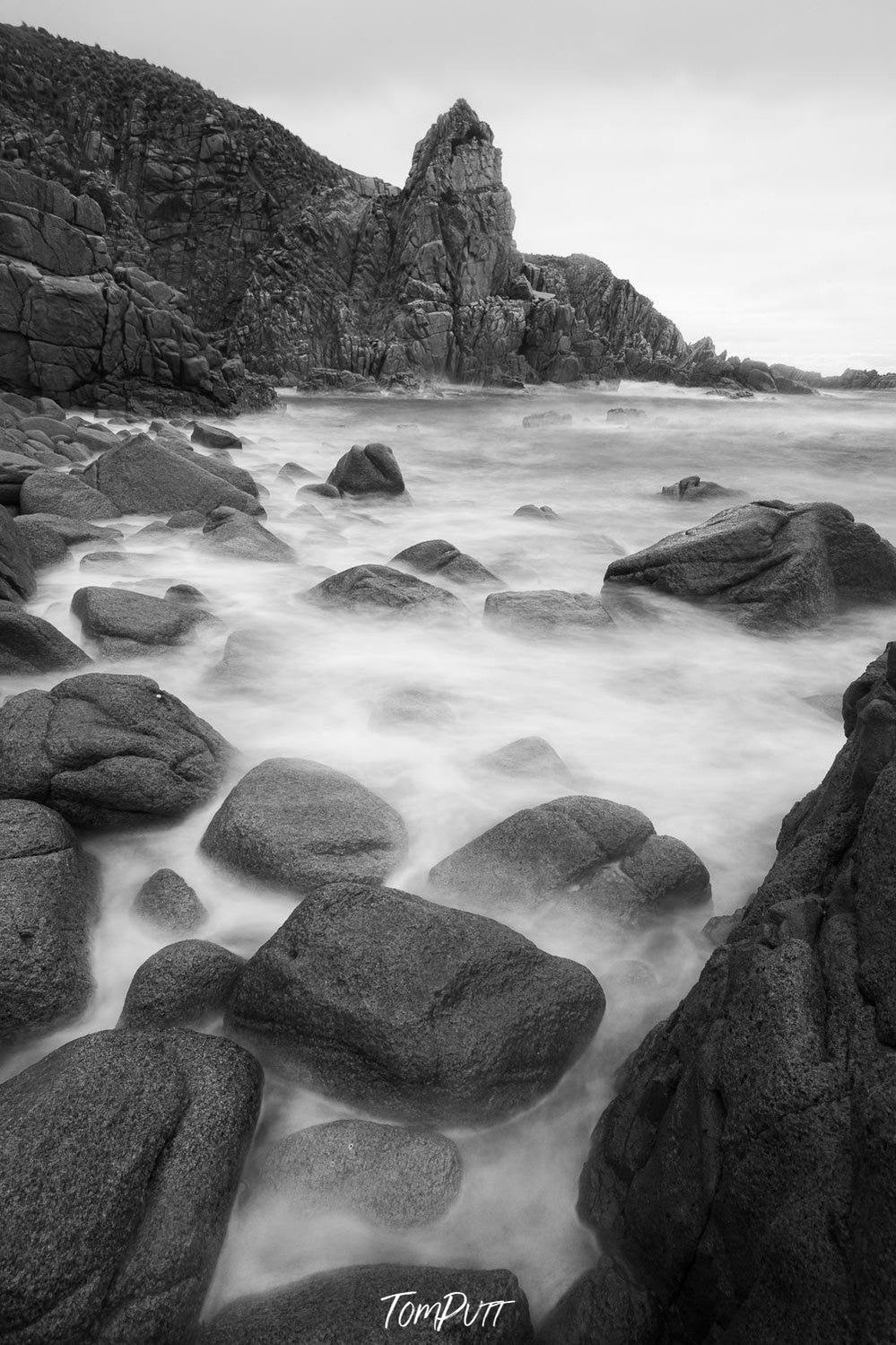 A beach with a lot of rounded stones and some standing sculpture of stones behind, The Pinnacles 5, Phillip Island