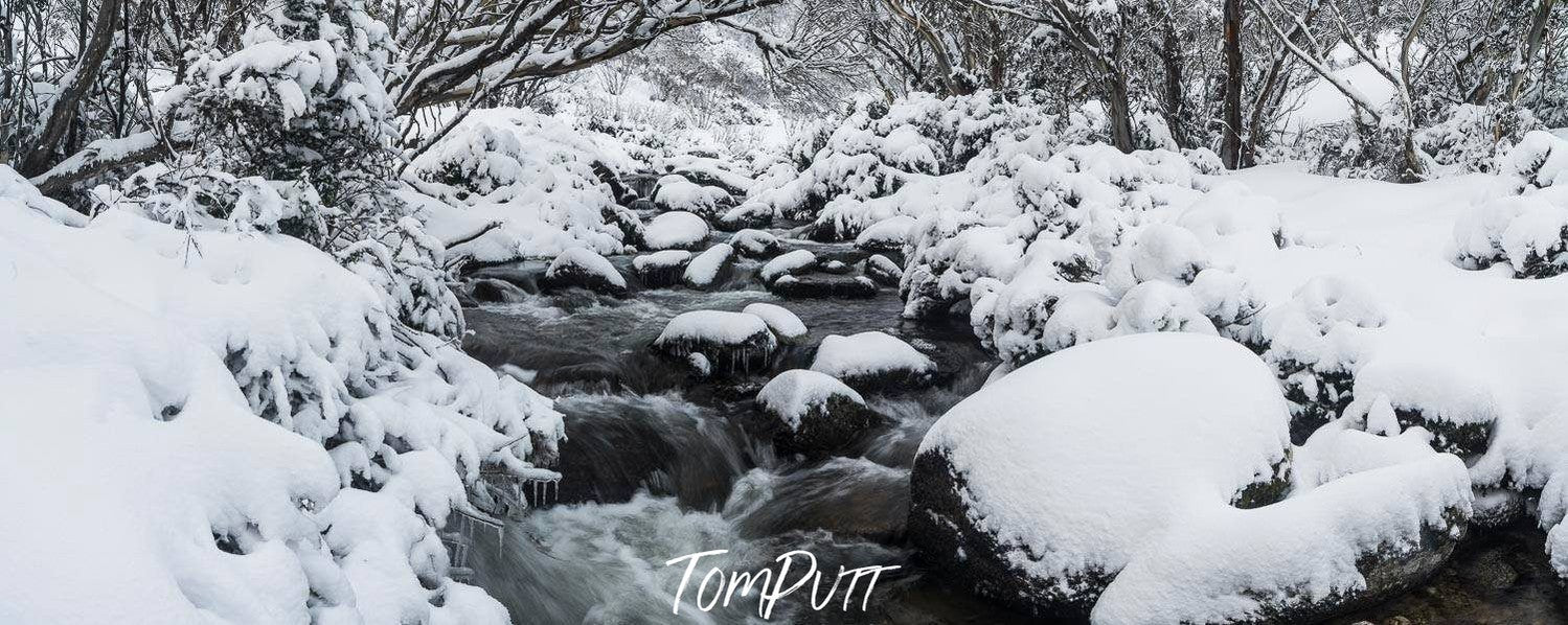 A watercourse with a lot of stones and fresh snow on them, Thredbo River - Snowy Mountains NSW