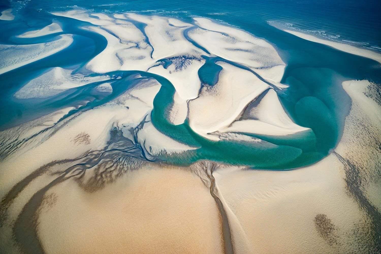 Aerial view of a sand with some unique blue-watered curves and lines, Tide Out, Broome