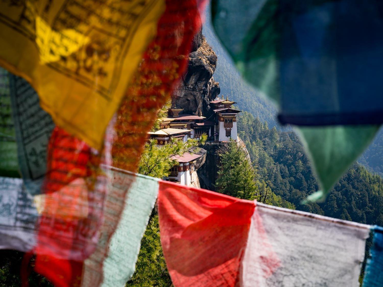Prayers flags in a sequence and a high hill area behind, Tiger's Nest with Prayer Flags, Bhutan
