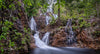Beautiful group of mini waterfalls coming from far away and connecting in a small watercourse with fresh plants and small trees in the surroundings, Arnhem Land 28 - Northern Territory 