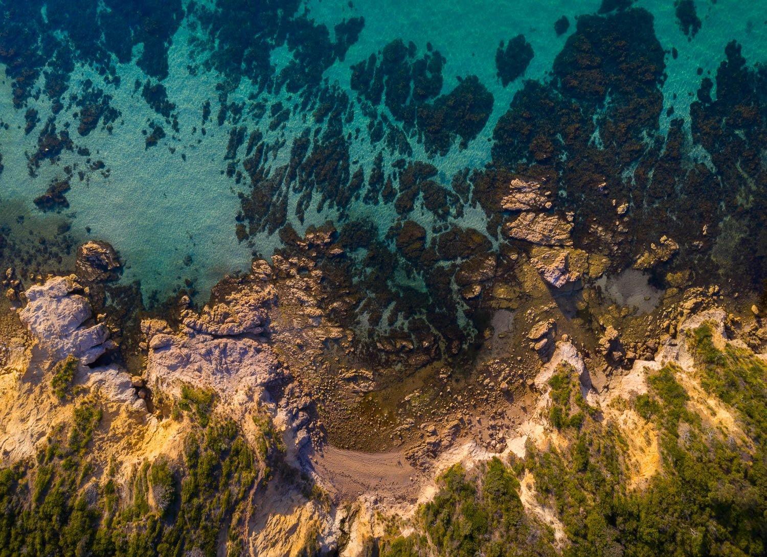 Aerial view of a giant mountain full of greenery, and a sea with greenery underwater below the mountain, Turquoise Waters, Mt Martha - Mornington Peninsula VIC