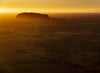 A giant golden mountain standing alone with the sunset effect, Uluru Dawn