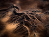 Giant sand curves and cracks over a dark desert, View From Above Artwork