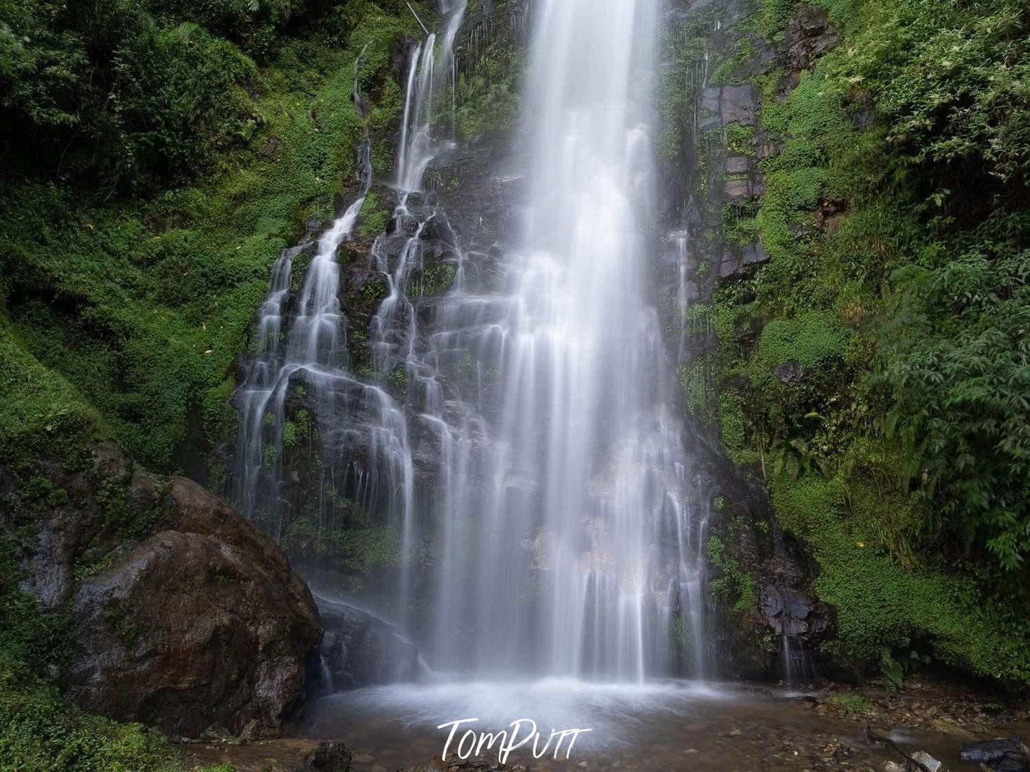 Massive waterfall from a green mountain into a small lake, Waterfall #2, Bhutan