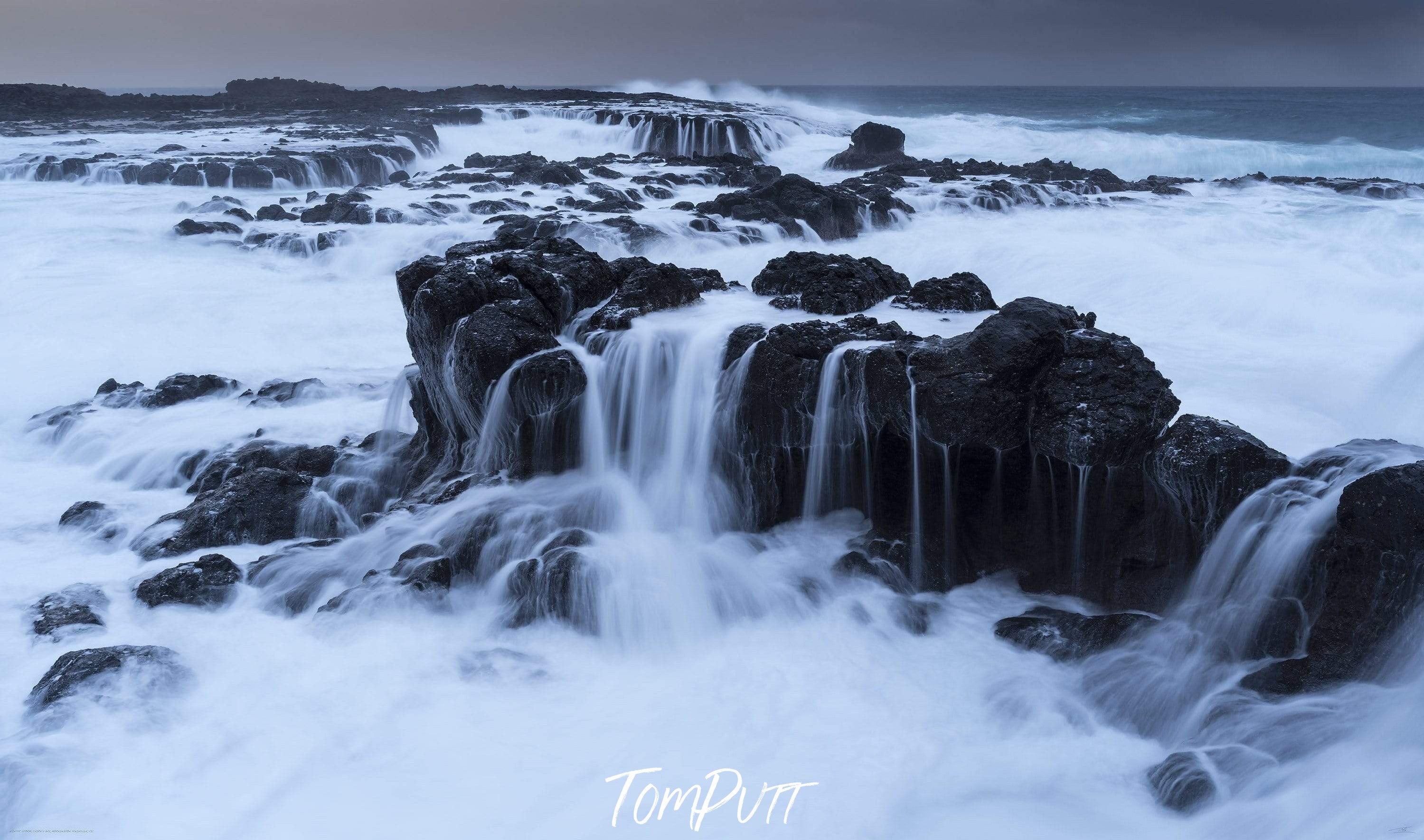 Giant rocky wall in a sea with a massive water flow over it, Winter's Storm, Mornington Peninsula, VIC