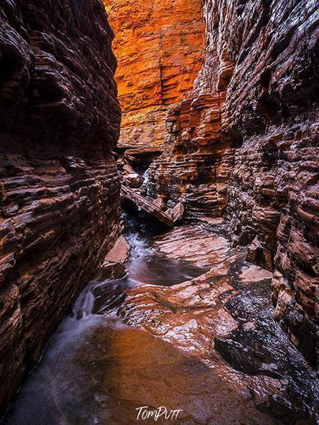 A pathway under giant rocky mountain walls of different burning shades, Weano Awakens - Karijini, The Pilbara