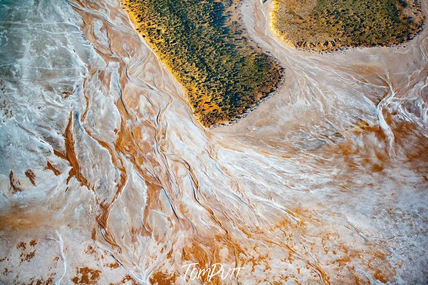 Aerial view of a large white oceanic surface with some big green mounds, Lake Wedge