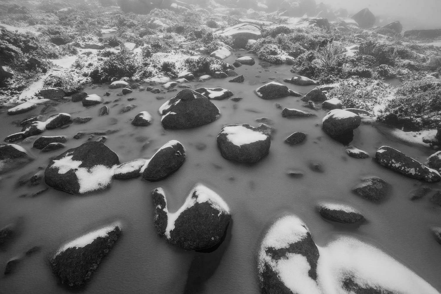 Big black stones on a small watercourse, Depicting chocolate chips, Wellington Winter - Mt Wellington TAS
