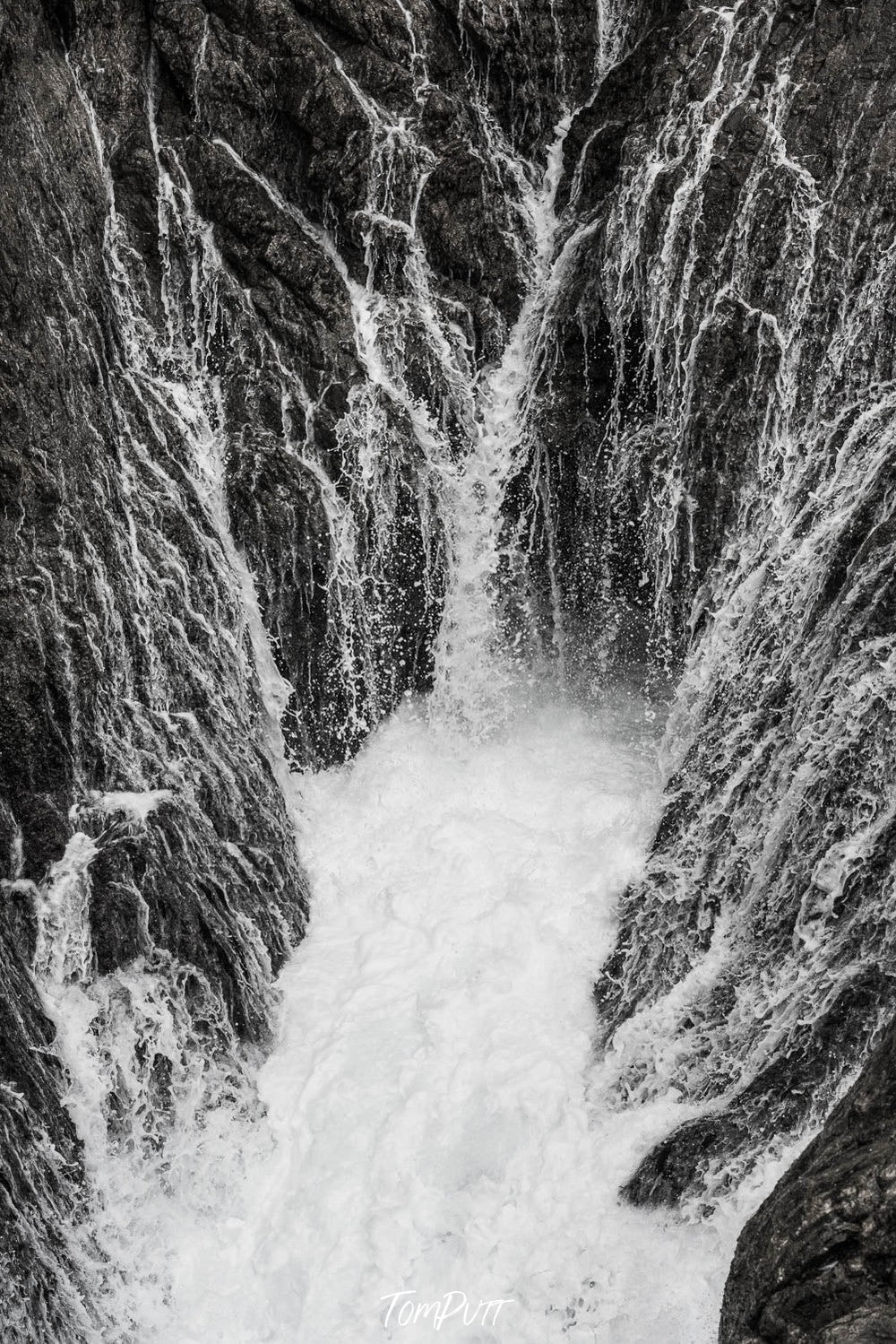 Massive bubbling water waves underneath a rocky mountain wall Whitewash, Eyre Peninsula