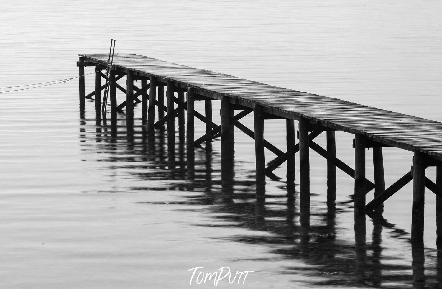 A drone view of a long wooden bridge over the ocean, Wooden Jetty, Bay of Fires