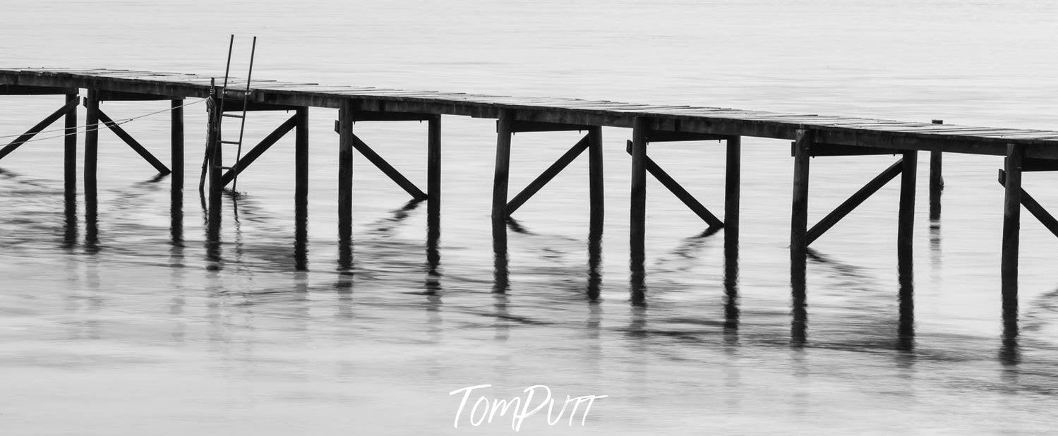 A drone view of a long wooden bridge over the ocean, Wooden Jetty abstract, Bay of Fires