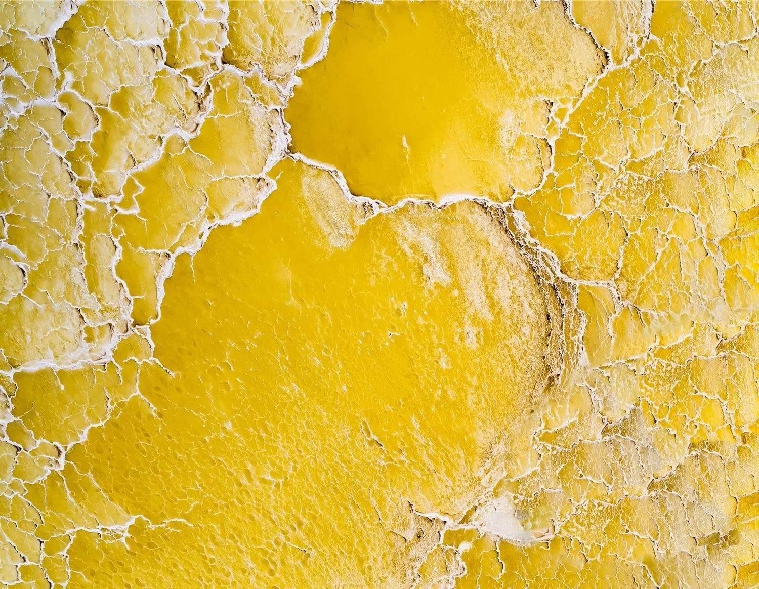 Aerial view of a yellow liquid land with white salt particles, Yellow Salt