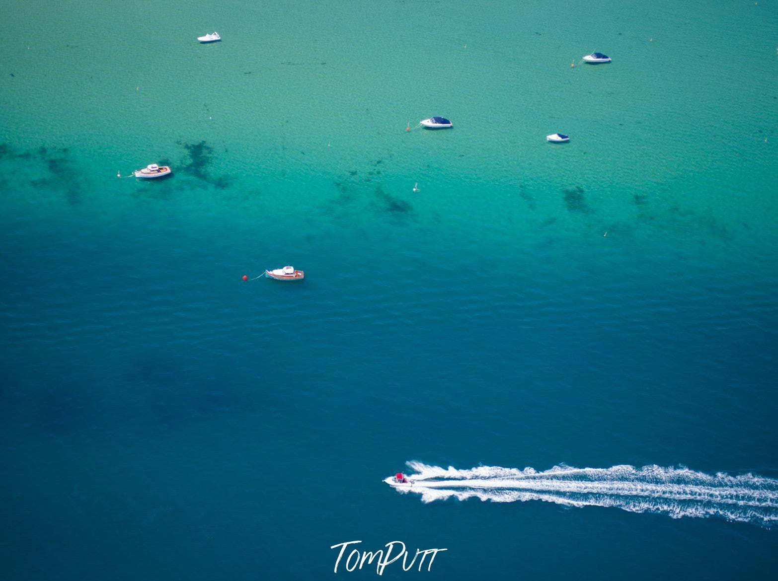 A long-shot drone view of a green ocean with some small and one big ship floating over, Zooming Along, Mornington Peninsula, VIC